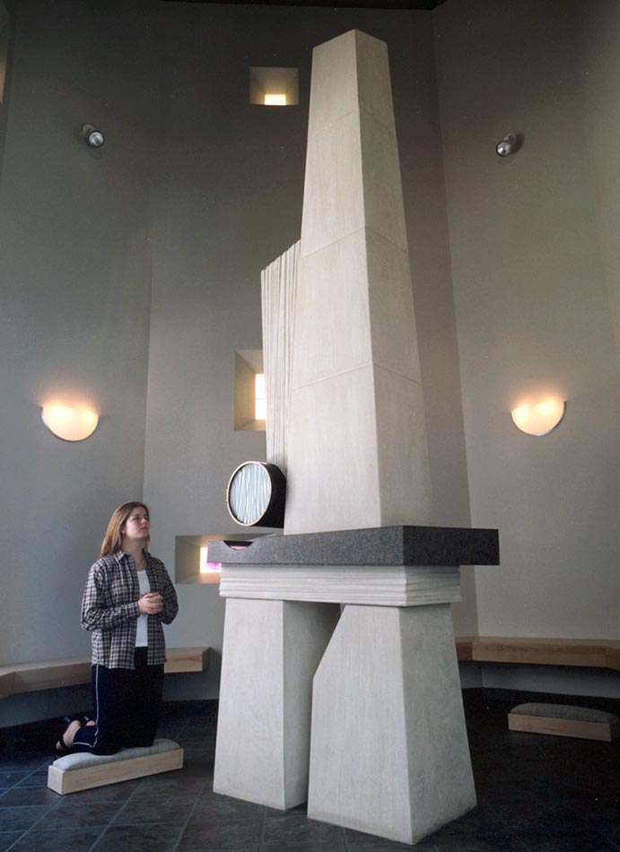 The Blessed Sacrament Chapel houses a 13-foot high limestone tabernacle with a bronze cylinder, which hovers over a granite shelf and holds the consecrated bread reserved for communion services and Viaticum.