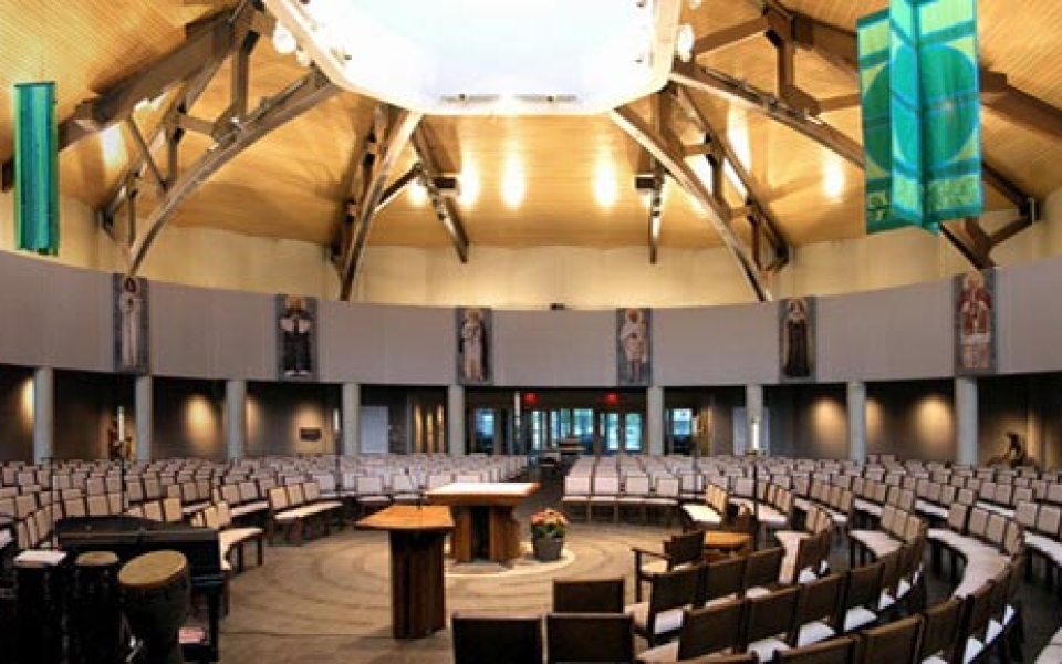 The low-ceilinged baptismal area leads into the soaring circular worship space which seats 560 people around the black walnut altar in the center, representing Christ. The ambo, which is on axis with the font and complements the altar, highlights the renewed emphasis on Scriptural proclamation and preaching.